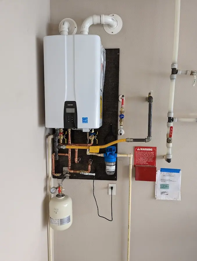 Professional plumber installing copper piping in a Oil City home